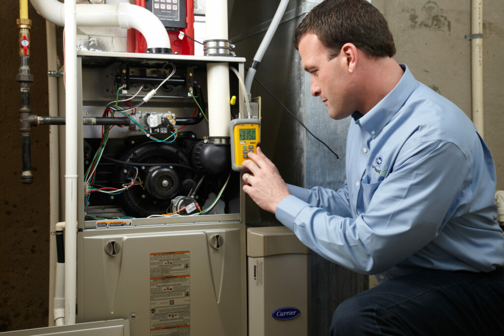Technician working on a commercial furnace making sure it is functioning properly